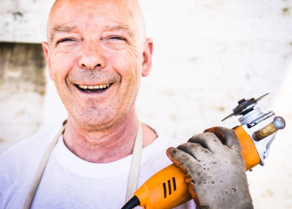 A workman smiles with his tools